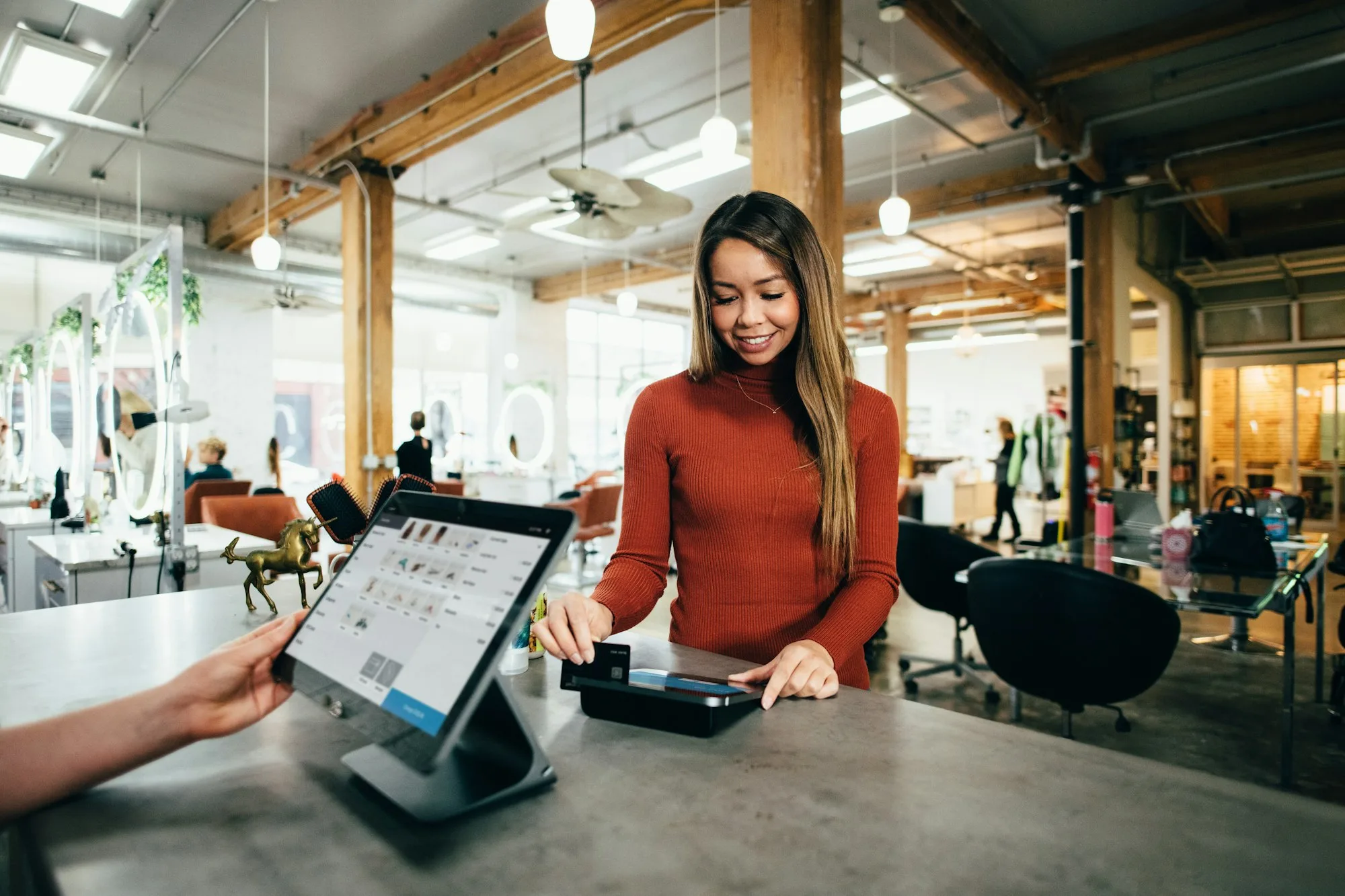 A shopper paying at a retail counter